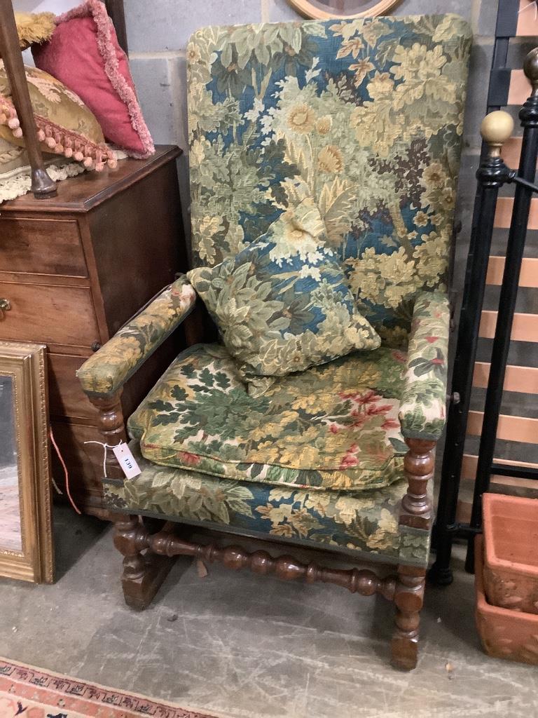 A Jacobean style carved walnut reclining armchair, with tapestry upholstery, width 68cm depth 60cm height 122cm